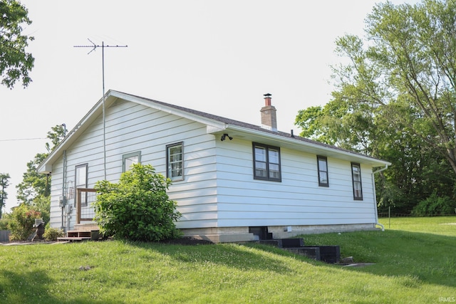 7420 S Fairfax Rd, Bloomington, IN 47401 - view of side of property featuring a yard and a chimney
