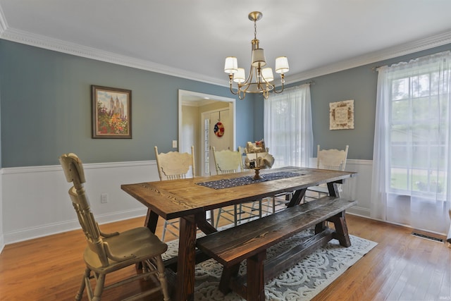 8855 Hickory Ln, Newburgh, IN 47630 - dining room featuring a chandelier, light wood finished floors, and crown molding