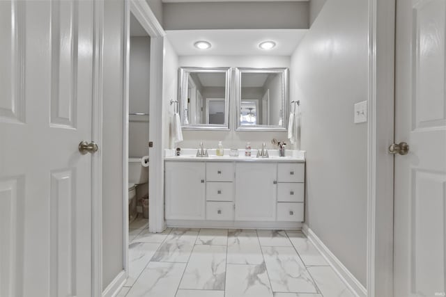 8855 Hickory Ln, Newburgh, IN 47630 - bathroom featuring marble look tiles, double vanity, and recessed lighting