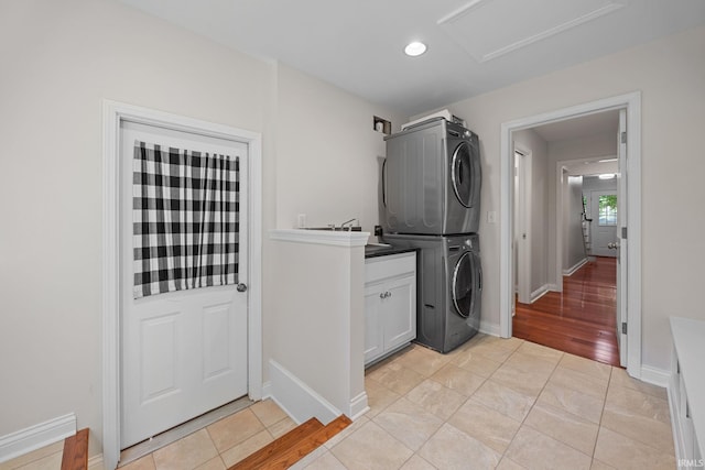 3726 Capilano Dr, West Lafayette, IN 47906 - laundry room featuring stacked washer / drying machine, cabinet space, attic access, recessed lighting, and light tile patterned floors
