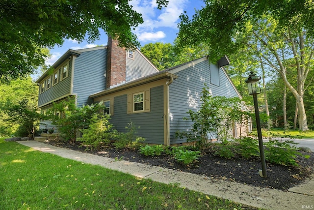 3726 Capilano Dr, West Lafayette, IN 47906 - view of property exterior with a chimney and a lawn