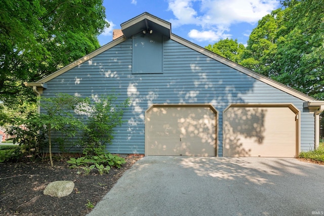 3726 Capilano Dr, West Lafayette, IN 47906 - view of property exterior with a chimney and asphalt driveway