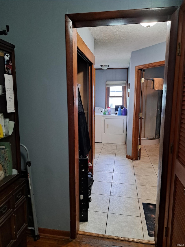 622 S Market St, Winamac, IN 46996 - hallway featuring independent washer and dryer and light tile patterned flooring