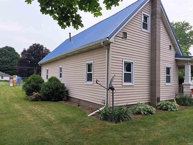 622 S Market St, Winamac, IN 46996 - view of side of property with a metal roof and a yard