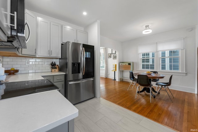 4230 Tacoma Ave, Fort Wayne, IN 46807 - kitchen featuring stainless steel appliances, light countertops, decorative backsplash, arched walkways, and recessed lighting