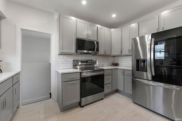 4230 Tacoma Ave, Fort Wayne, IN 46807 - kitchen featuring stainless steel appliances, gray cabinets, backsplash, light countertops, and recessed lighting