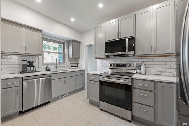 4230 Tacoma Ave, Fort Wayne, IN 46807 - kitchen with stainless steel appliances, gray cabinetry, tasteful backsplash, light countertops, and recessed lighting