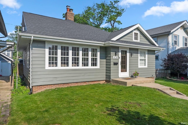 4230 Tacoma Ave, Fort Wayne, IN 46807 - bungalow with a front lawn, a chimney, and a shingled roof