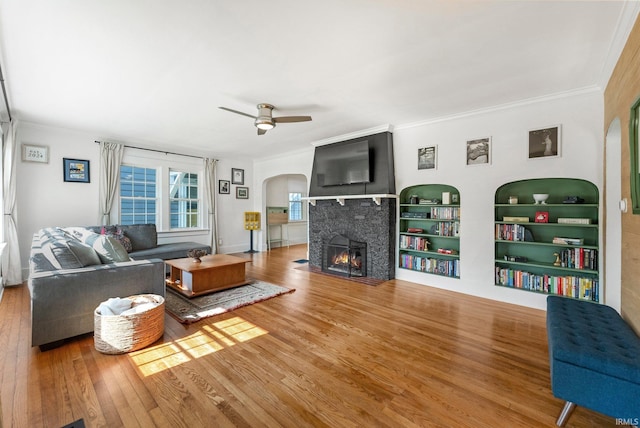 4230 Tacoma Ave, Fort Wayne, IN 46807 - living area with arched walkways, wood finished floors, a fireplace, crown molding, and a ceiling fan