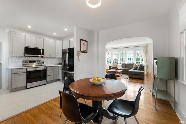 4230 Tacoma Ave, Fort Wayne, IN 46807 - dining space with arched walkways, light wood-type flooring, and recessed lighting