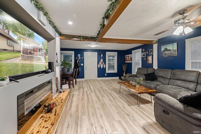919 S 18th St, Lafayette, IN 47905 - living room featuring wood finished floors, a ceiling fan, beam ceiling, and a textured ceiling