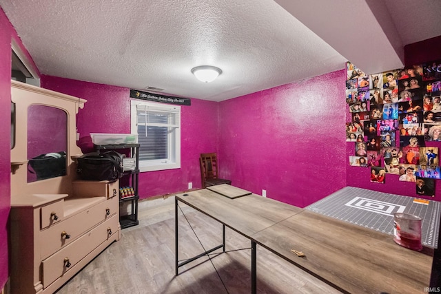 919 S 18th St, Lafayette, IN 47905 - bedroom with light wood-type flooring, a textured ceiling, and a textured wall