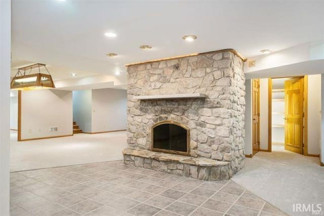 7030 Windshire Dr, Fort Wayne, IN 46814 - unfurnished living room with carpet flooring, stairway, a stone fireplace, tile patterned floors, and recessed lighting