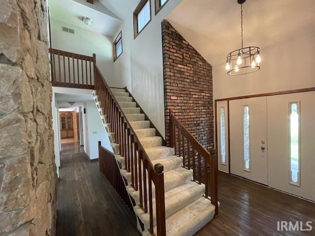 7030 Windshire Dr, Fort Wayne, IN 46814 - entryway with high vaulted ceiling, hardwood / wood-style floors, stairs, and a chandelier