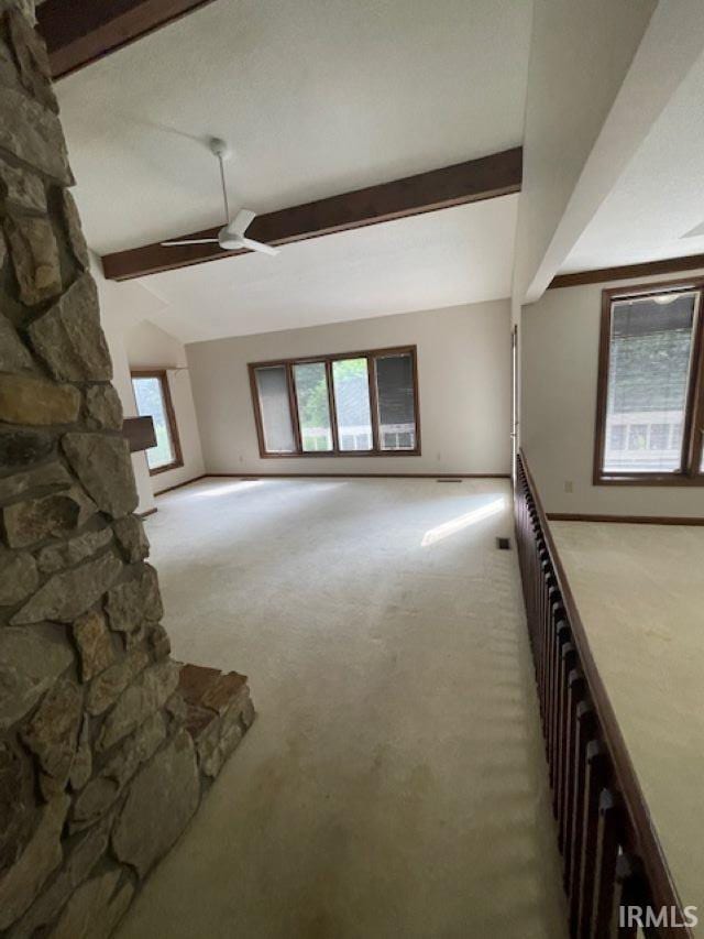 7030 Windshire Dr, Fort Wayne, IN 46814 - unfurnished living room featuring carpet floors, beamed ceiling, and ceiling fan