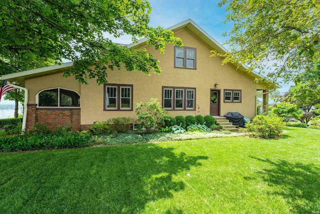 209 S 2nd St, Rockport, IN 47635 - view of front facade with stucco siding and a front yard