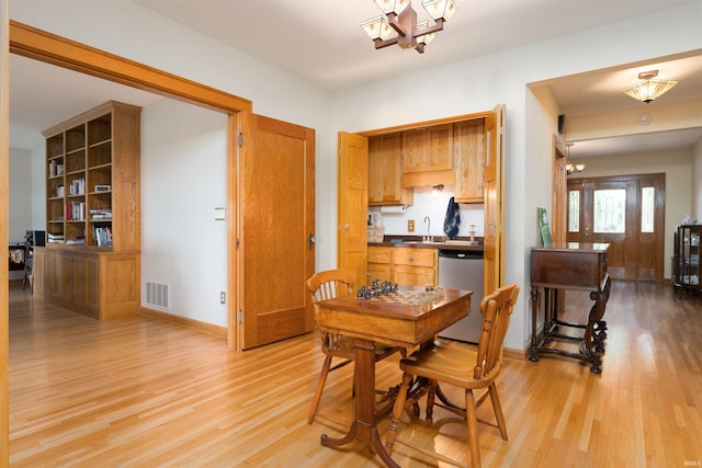 209 S 2nd St, Rockport, IN 47635 - dining room with light wood-type flooring and a chandelier