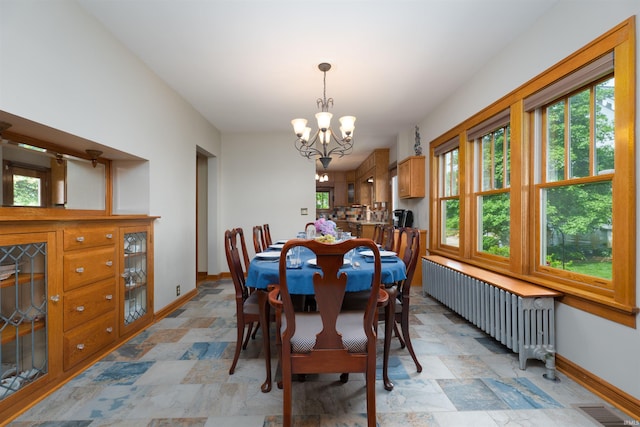 209 S 2nd St, Rockport, IN 47635 - dining space with radiator heating unit, a chandelier, and stone finish flooring