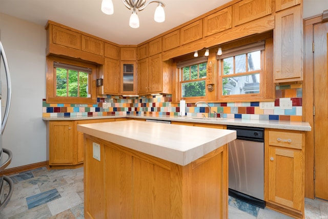 209 S 2nd St, Rockport, IN 47635 - kitchen featuring backsplash, light countertops, a chandelier, a kitchen island, and plenty of natural light