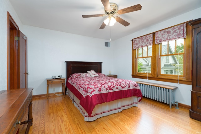 209 S 2nd St, Rockport, IN 47635 - bedroom with radiator heating unit, light wood finished floors, and ceiling fan