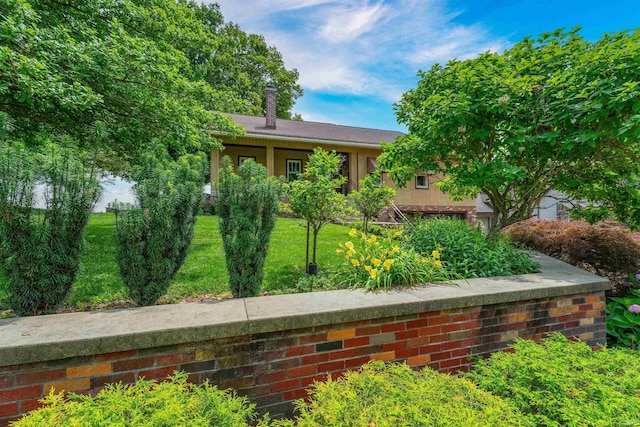 209 S 2nd St, Rockport, IN 47635 - view of front of property featuring a chimney, a front lawn, and stucco siding