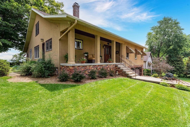 209 S 2nd St, Rockport, IN 47635 - view of front of property featuring stucco siding, a chimney, a front lawn, and covered porch