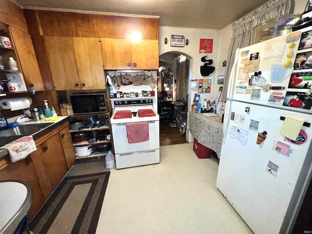 413 W 2nd St, Mount Carmel, IL 62863 - kitchen with white appliances, arched walkways, and brown cabinets