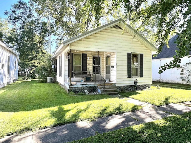 413 W 2nd St, Mount Carmel, IL 62863 - shotgun-style home featuring a porch and a front yard