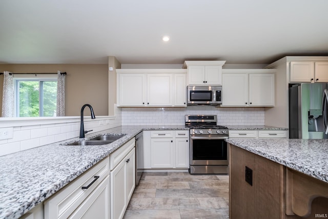 305 Hill Top Ct, New Carlisle, IN 46552 - kitchen featuring stainless steel appliances, tasteful backsplash, white cabinetry, light stone counters, and recessed lighting