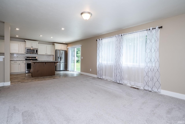 305 Hill Top Ct, New Carlisle, IN 46552 - unfurnished living room featuring light colored carpet and recessed lighting