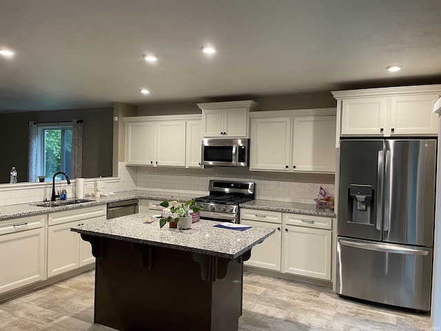 305 Hill Top Ct, New Carlisle, IN 46552 - kitchen featuring appliances with stainless steel finishes, white cabinetry, light wood finished floors, backsplash, and recessed lighting
