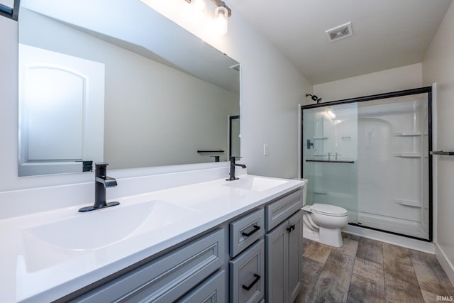 305 Hill Top Ct, New Carlisle, IN 46552 - bathroom featuring an enclosed shower, double vanity, and wood finished floors