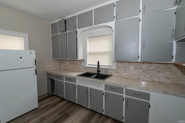 1722 Nash St, South Bend, IN 46613 - kitchen with freestanding refrigerator, tasteful backsplash, dark wood-style floors, and light countertops