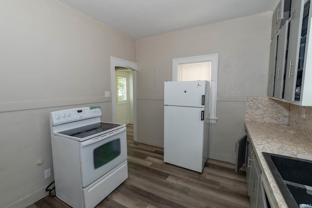 1722 Nash St, South Bend, IN 46613 - kitchen with white appliances, light countertops, dark wood-type flooring, and arched walkways