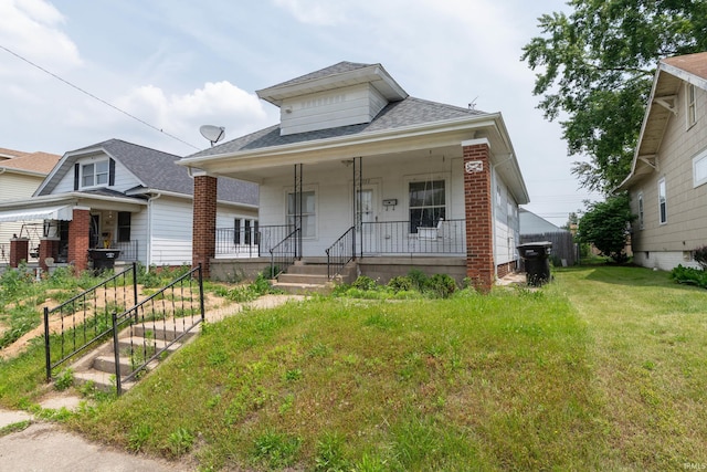 1722 Nash St, South Bend, IN 46613 - bungalow with roof with shingles, a porch, brick siding, and a front lawn