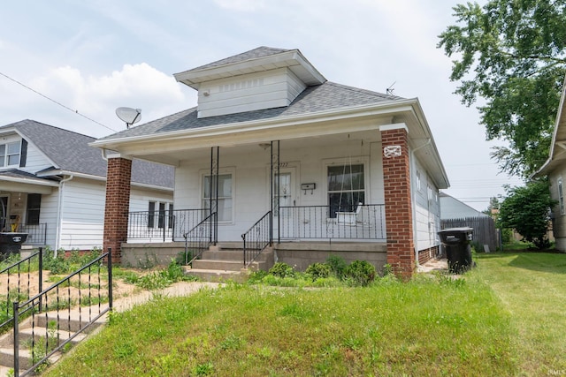 1722 Nash St, South Bend, IN 46613 - view of front of property with roof with shingles, covered porch, and a front yard