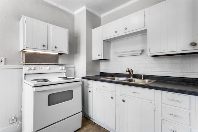 906 S Union St, Kokomo, IN 46901 - kitchen featuring white electric range, white cabinetry, crown molding, dark countertops, and a wainscoted wall