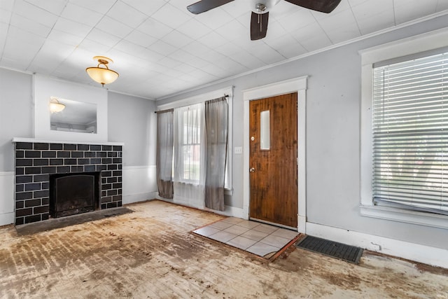906 S Union St, Kokomo, IN 46901 - unfurnished living room with crown molding, a fireplace, ceiling fan, and wood finished floors