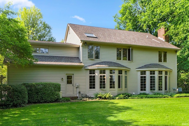 12217 Bay Heights Blvd, Grabill, IN 46741 - back of property featuring a chimney, a yard, and a shingled roof