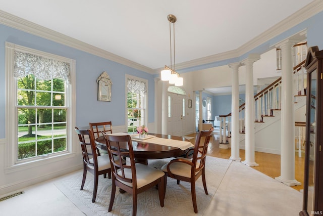 12217 Bay Heights Blvd, Grabill, IN 46741 - dining room featuring healthy amount of natural light, ornamental molding, ornate columns, and light wood-type flooring