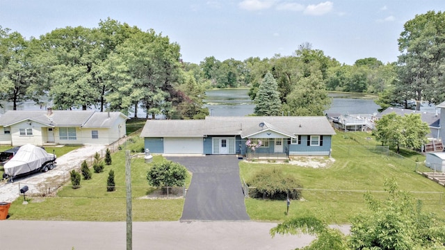 2885 E Bradford Ct, Monon, IN 47959 - view of front of property featuring driveway, a water view, and an attached garage