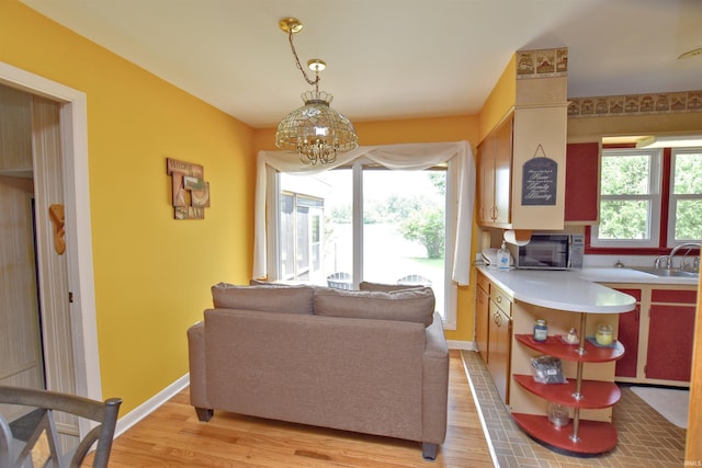 2885 E Bradford Ct, Monon, IN 47959 - living room with light wood finished floors and a chandelier