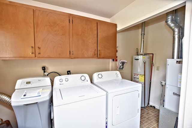 2885 E Bradford Ct, Monon, IN 47959 - laundry area with cabinet space, water heater, washer and clothes dryer, and brick patterned flooring