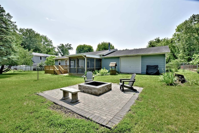 2885 E Bradford Ct, Monon, IN 47959 - rear view of house with a fire pit, a sunroom, a wooden deck, and a patio
