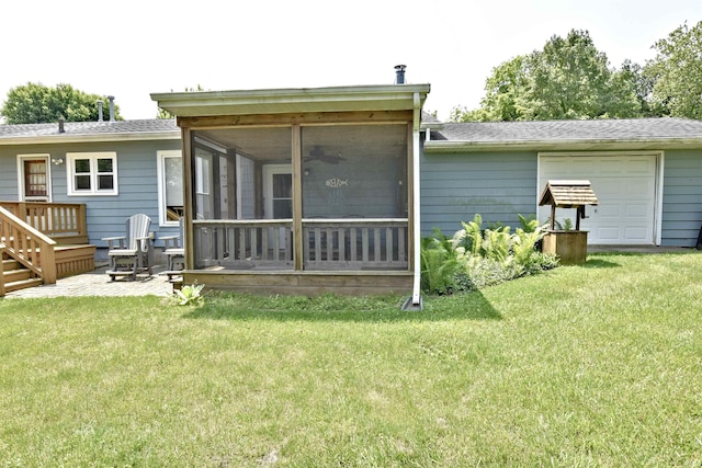 2885 E Bradford Ct, Monon, IN 47959 - back of house with a sunroom, a garage, a yard, and ceiling fan