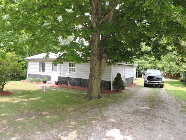 5294 W Finch Rd, Claypool, IN 46510 - view of front of property featuring stone siding, a front yard, and dirt driveway