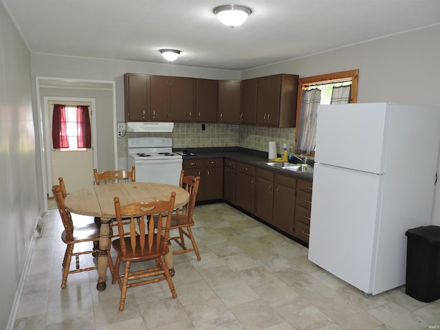 5294 W Finch Rd, Claypool, IN 46510 - kitchen featuring white appliances, extractor fan, dark countertops, and dark brown cabinetry