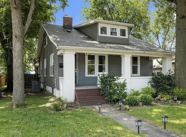 2015 E Blackford Ave, Evansville, IN 47714 - bungalow with a porch, a chimney, brick siding, and roof with shingles