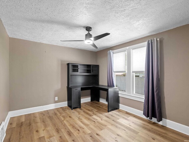 2015 E Blackford Ave, Evansville, IN 47714 - unfurnished office featuring ceiling fan, light wood-type flooring, and a textured ceiling