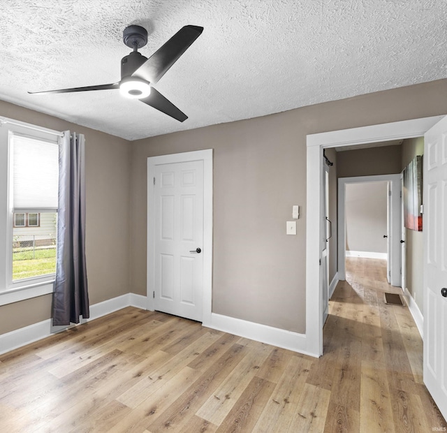 2015 E Blackford Ave, Evansville, IN 47714 - unfurnished bedroom with a textured ceiling, light wood-type flooring, and a ceiling fan